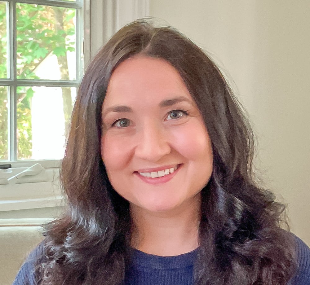 Tanya Fridland, LCSW, smiling, in a navy sweater beside a sunlit window